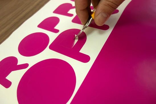 Atelier d'imprimerie industrielle avec opérateur manipulant des publications sur machine offset